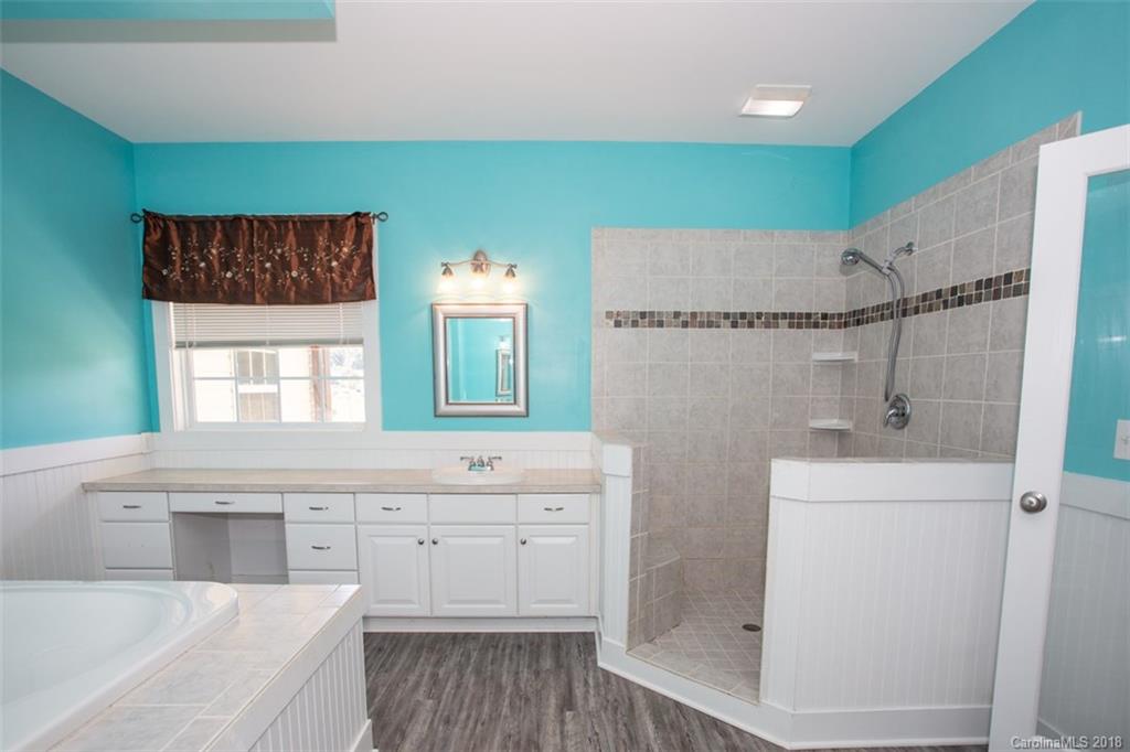 122 Barrier Farms Road Midland, NC 28107 - Photo 23 of 33 a spacious bathroom with a double vanity sink a mirror and a bathtub