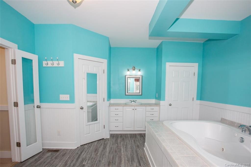 122 Barrier Farms Road Midland, NC 28107 - Photo 24 of 33 a bathroom with a bathtub sink and mirror