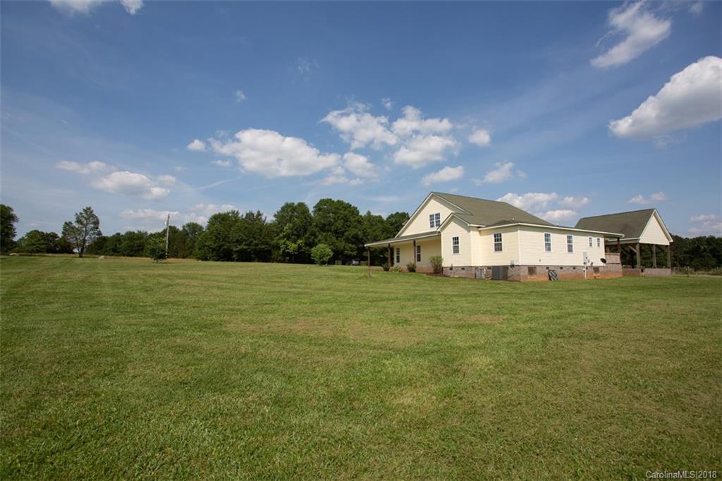 122 Barrier Farms Road Midland, NC 28107 - Photo 31 of 33 a front view of a house with a garden