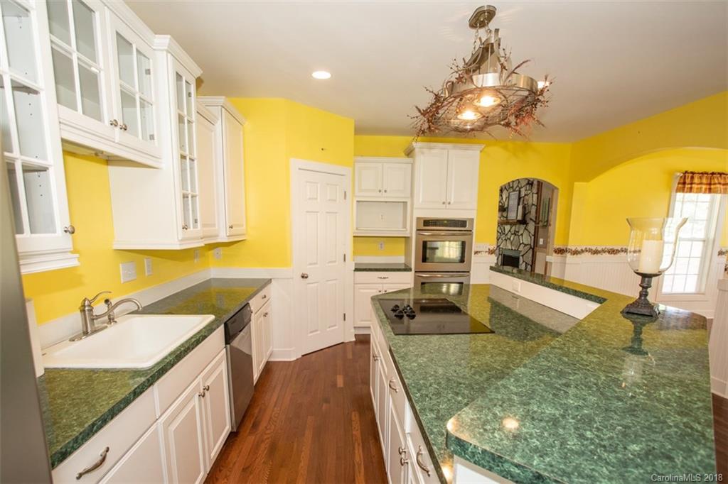 122 Barrier Farms Road Midland, NC 28107 - Photo 9 of 33 a kitchen with a sink a counter top space and living room view