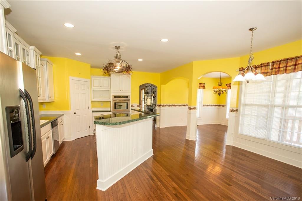 122 Barrier Farms Road Midland, NC 28107 - Photo 10 of 33 a kitchen with stainless steel appliances granite countertop a sink a stove and a wooden floors