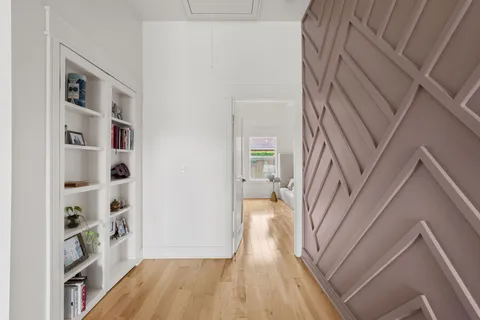 a view of a hallway view with wooden floor and staircase
