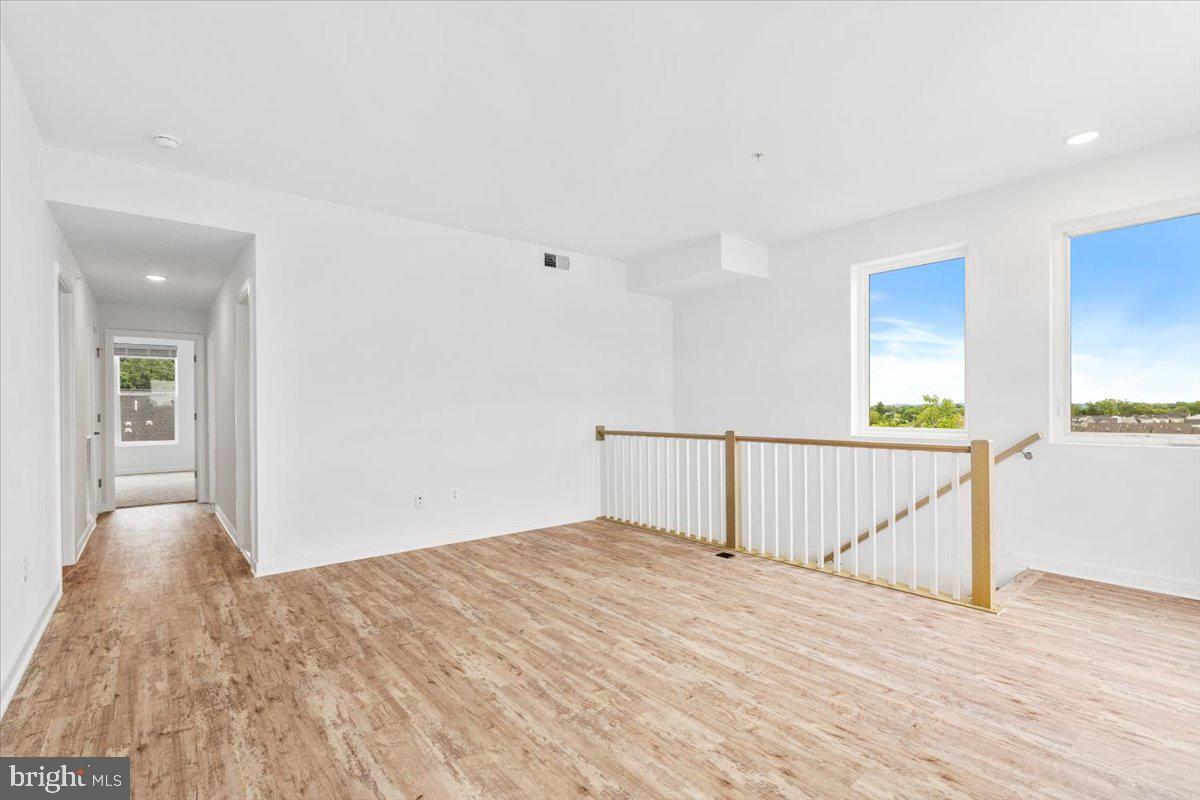 1618 A Blacksmith Way Frederick, MD 21702 - Photo 19 of 45 a view of a room with wooden floor