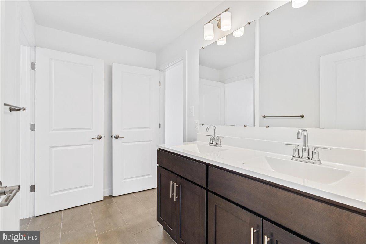 1618 A Blacksmith Way Frederick, MD 21702 - Photo 39 of 45 a bathroom with a double vanity sink a mirror and a shower