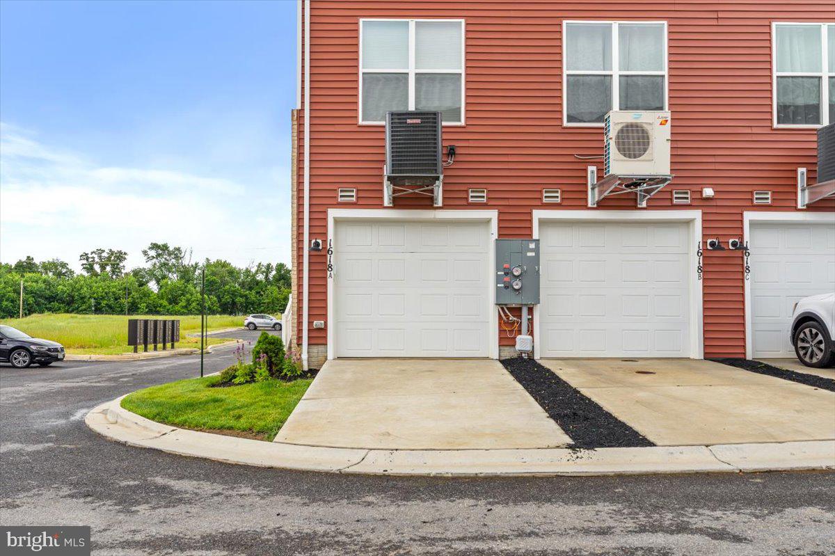 1618 A Blacksmith Way Frederick, MD 21702 - Photo 43 of 45 a front view of a house with a yard and garage