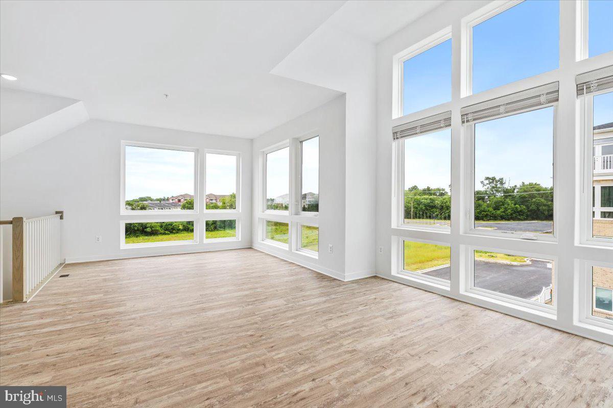 1618 A Blacksmith Way Frederick, MD 21702 - Photo 6 of 45 a view of an empty room with a large window with swimming pool in front of it
