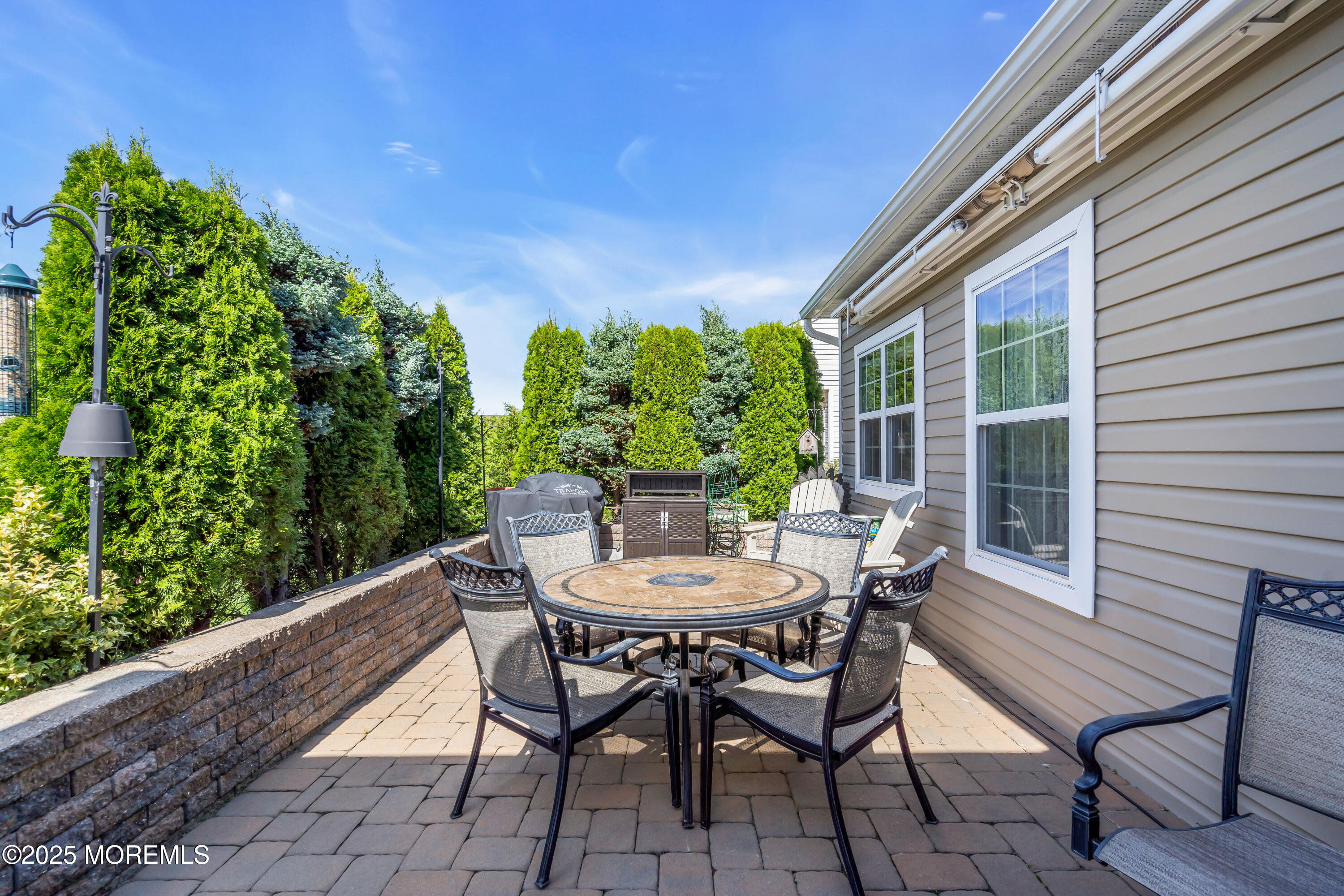 8 Ventnor Court Waretown, NJ 08758 - Photo 37 of 42 a view of a wooden chairs and table in patio of the house