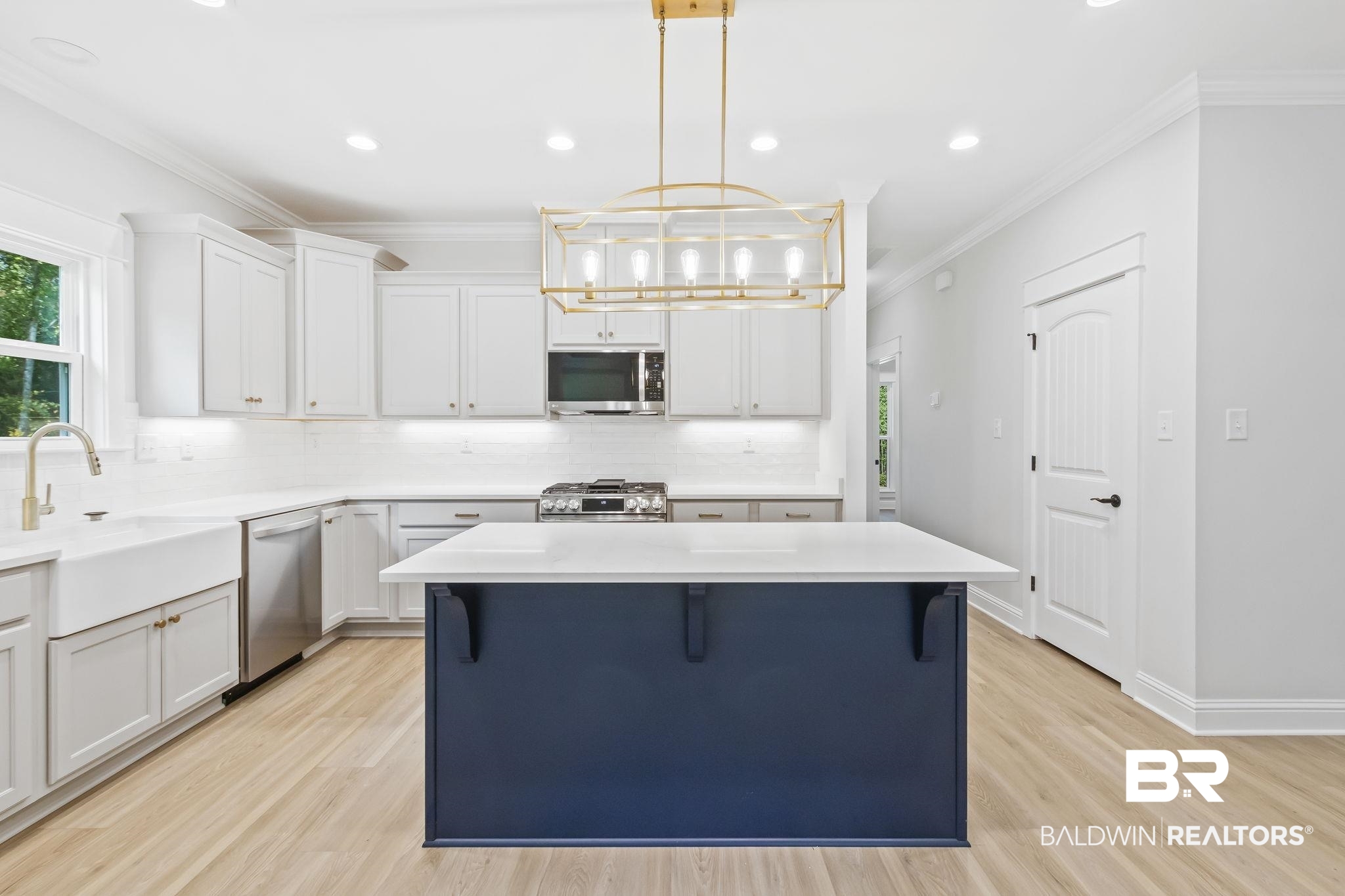12130 Reunion Place Foley, AL 36535 - Photo 12 of 42 Kitchen with appliances with stainless steel finishes, a kitchen island, light wood-type flooring, and pendant lighting