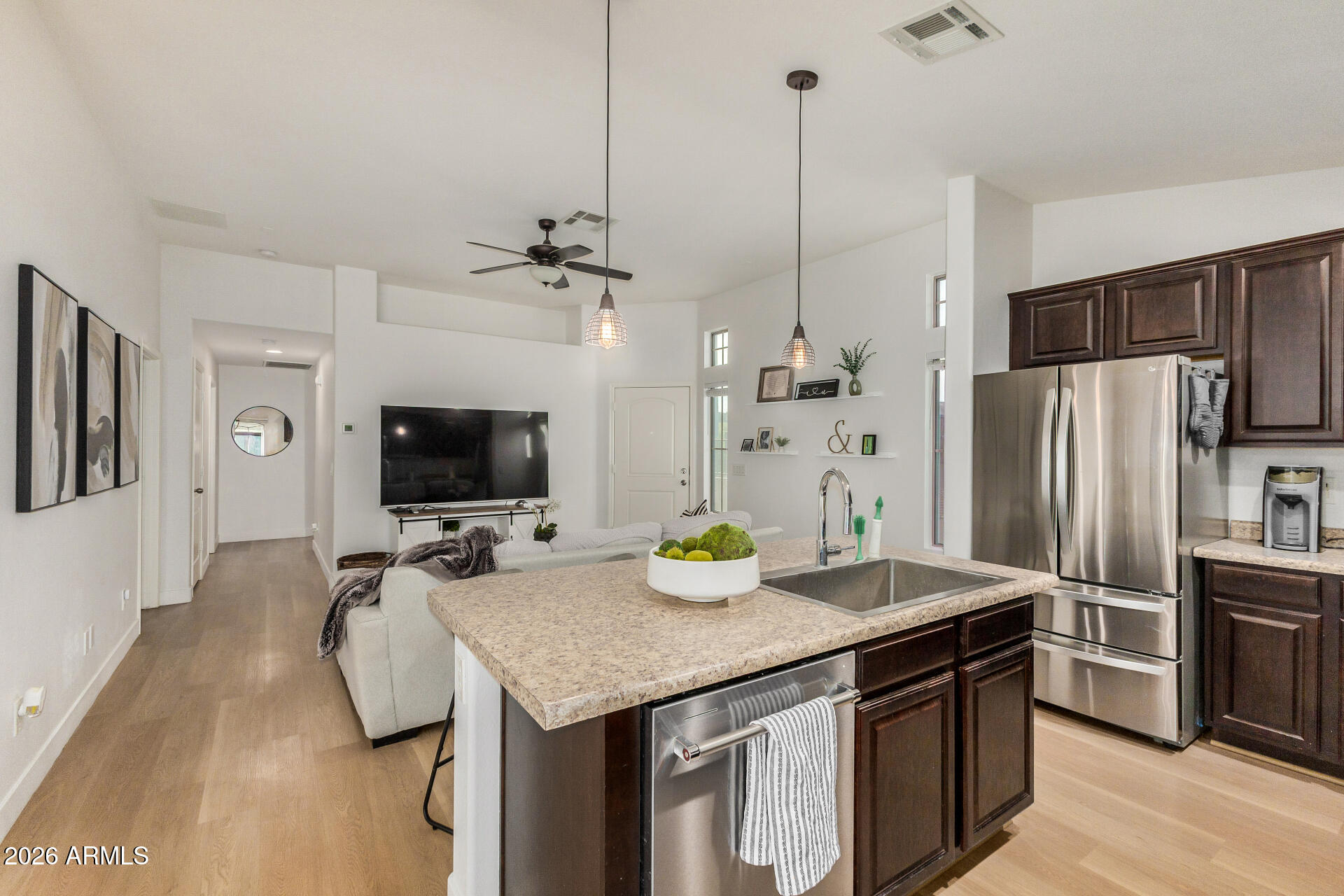 2725 East Mine Creek Road, Unit 1101 Phoenix, AZ 85024 - Photo 12 of 43 a kitchen with kitchen island a sink dining table and chairs