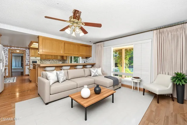 a kitchen with stainless steel appliances granite countertop a sink and wooden cabinets