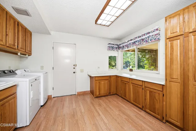 a view of a room with a fireplace and large windows