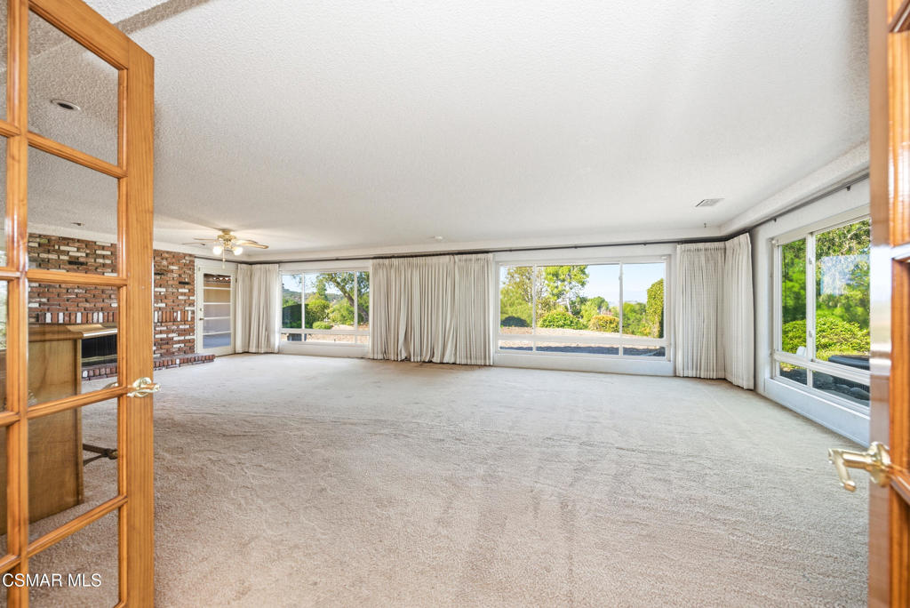 39 Inverness Road Thousand Oaks, CA 91361 - Photo 31 of 69 a view of an empty room with a fireplace and windows