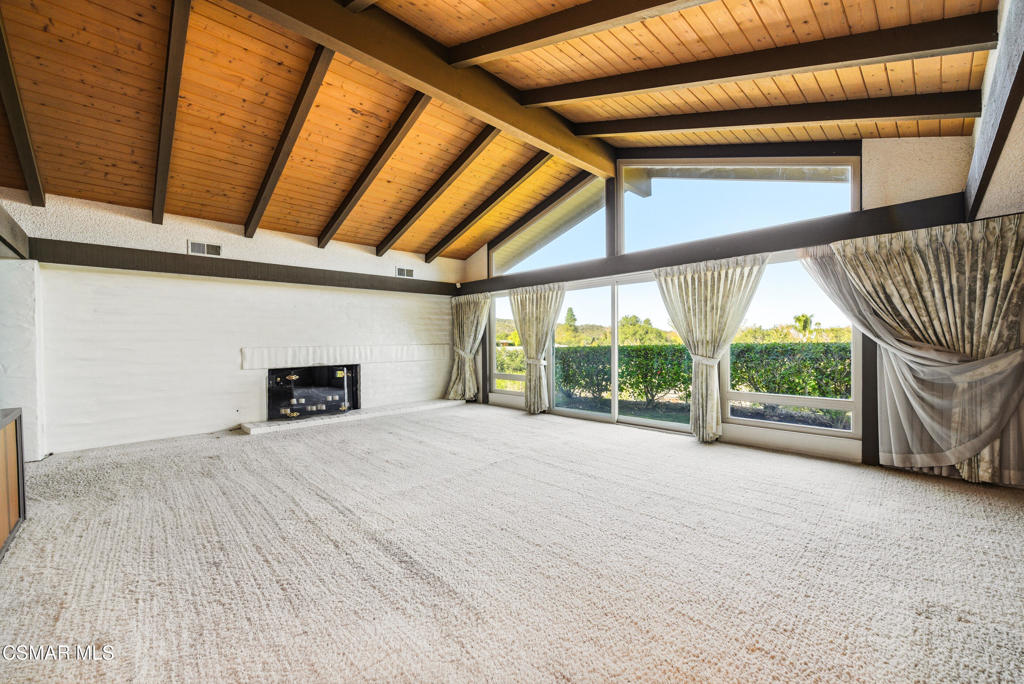 39 Inverness Road Thousand Oaks, CA 91361 - Photo 10 of 69 a view of an empty room with a fireplace and a window