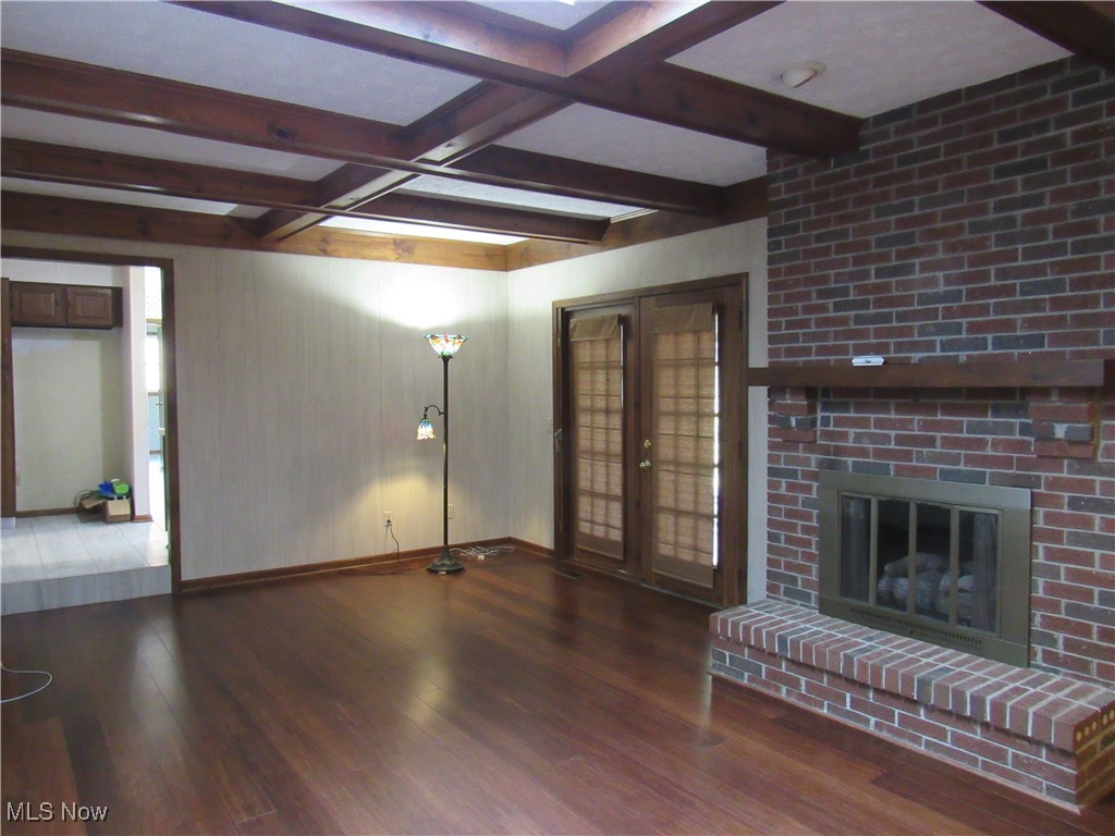 1120 Vincent Road Southeast North Canton, OH 44720 - Photo 21 of 50 Great Room with dark hardwood / wood-style floors, french doors, brick gas fireplace and built in Bookcase