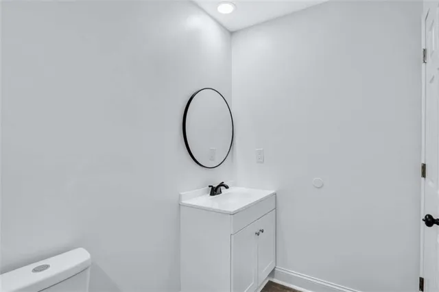 a bathroom with a sink a mirror and a toilet