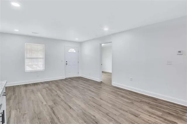 wooden floor in an empty room with a window
