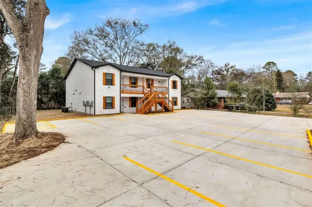 a view of a house with snow on the road
