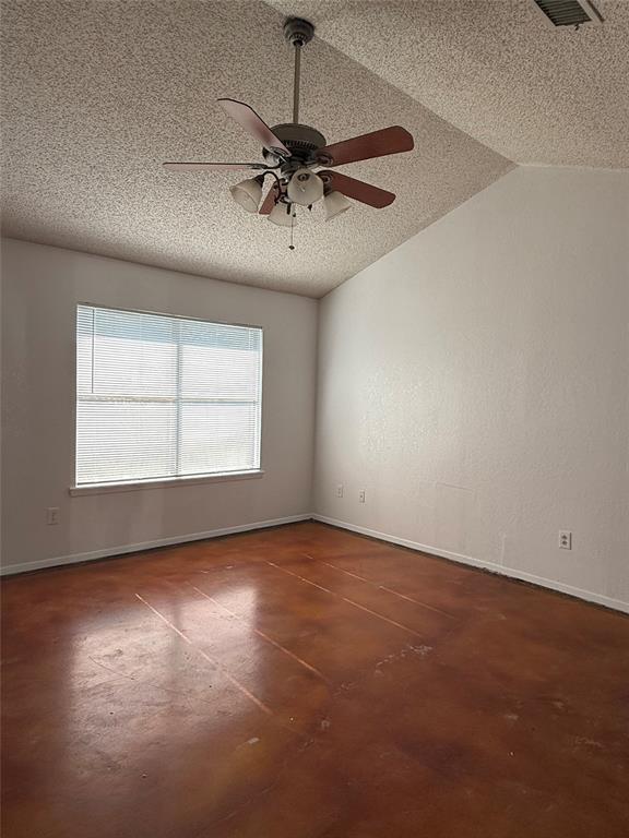 3757 Trinity Lane Abilene, TX 79602 - Photo 12 of 40 an empty room with a chandelier fan and windows