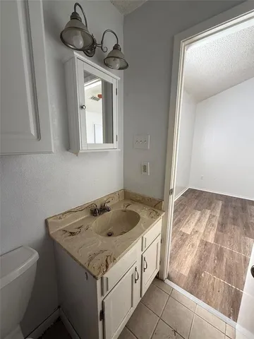 a bathroom with a granite countertop sink and a mirror