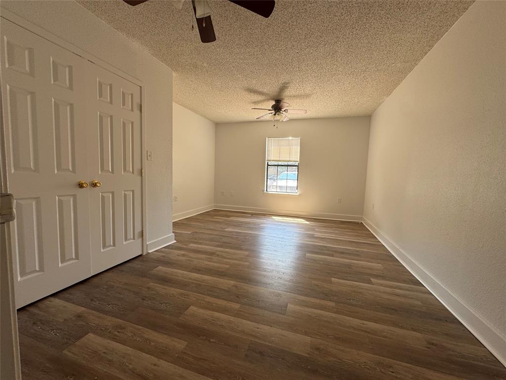 3757 Trinity Lane Abilene, TX 79602 - Photo 29 of 40 a view of an empty room with a window and wooden floor