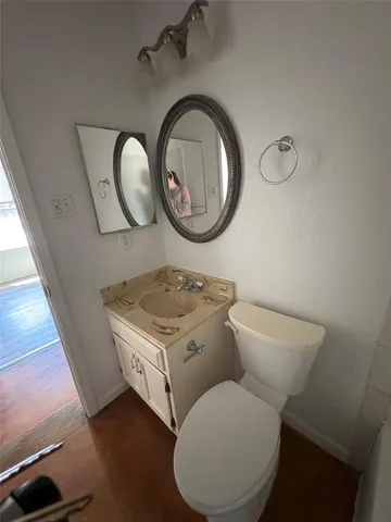 a bathroom with a toilet a sink and a mirror