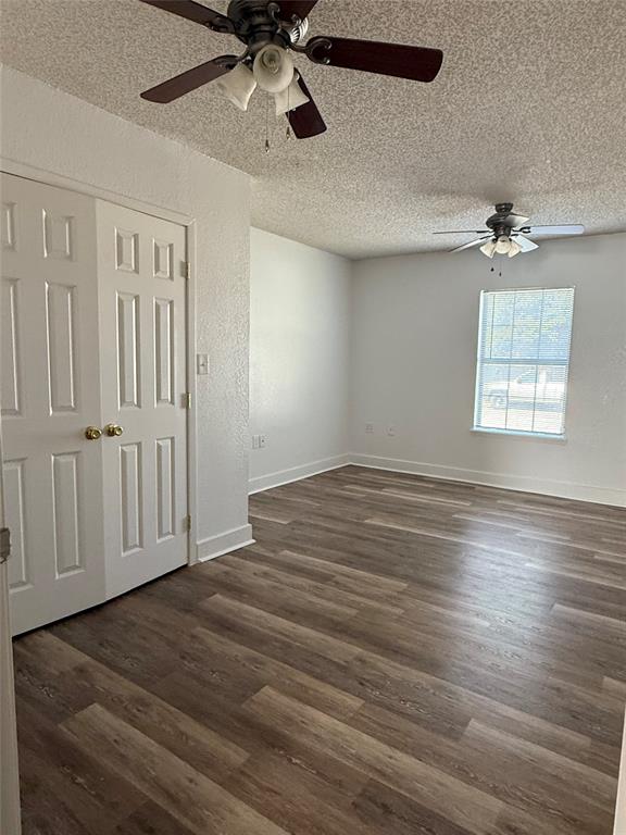 3757 Trinity Lane Abilene, TX 79602 - Photo 7 of 40 an empty room with wooden floor chandelier fan and windows