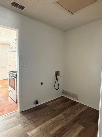 a view of a room with wooden floor and windows