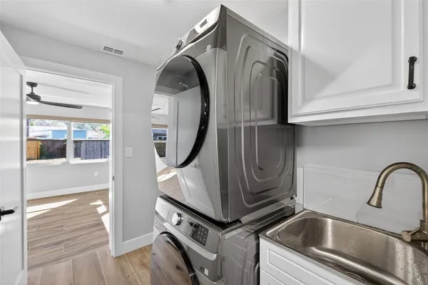 a utility room with sink dryer and washer