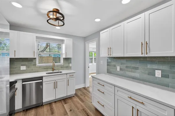 a kitchen with appliances cabinets and a window