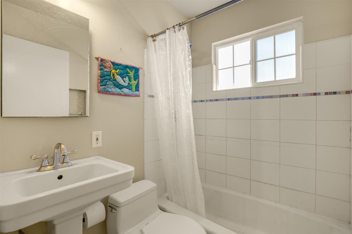 406 Pine Street, Unit A Capitola, CA 95010 - Photo 12 of 32 a bathroom with a sink a toilet and shower