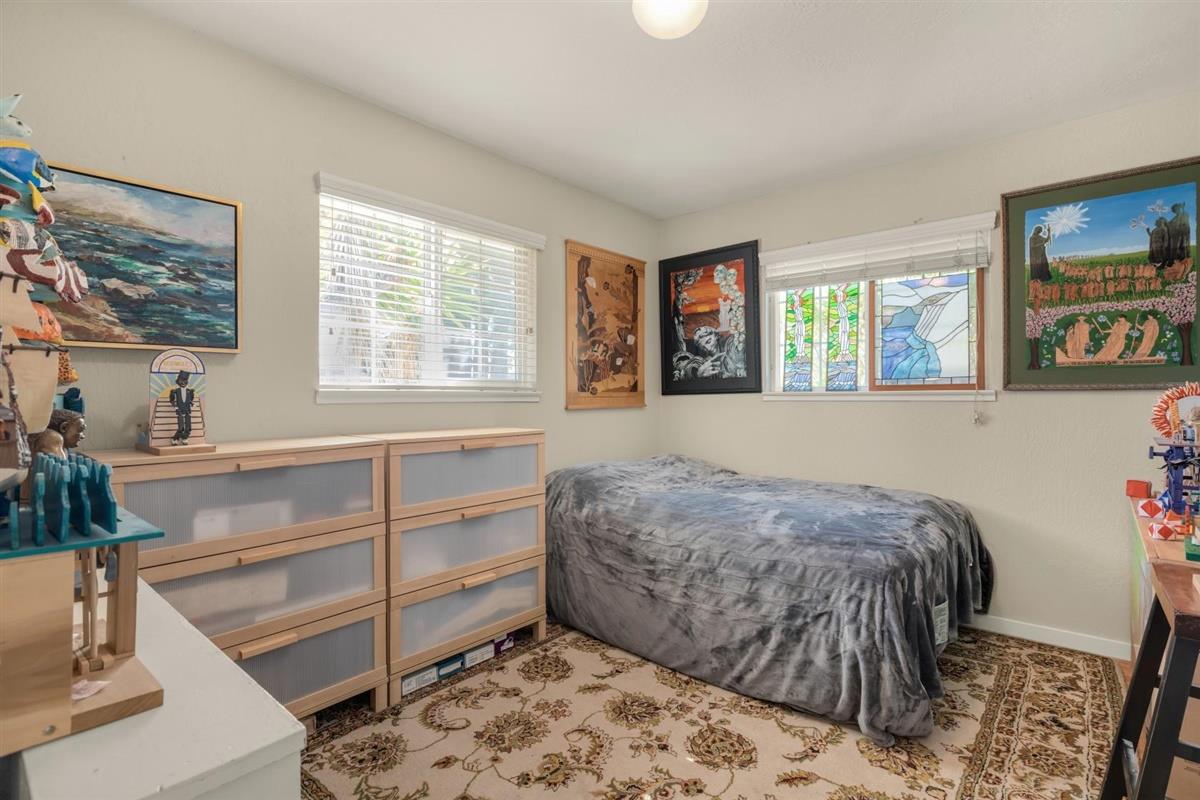 406 Pine Street, Unit A Capitola, CA 95010 - Photo 13 of 32 a bedroom with a bed and a window with the potted plant