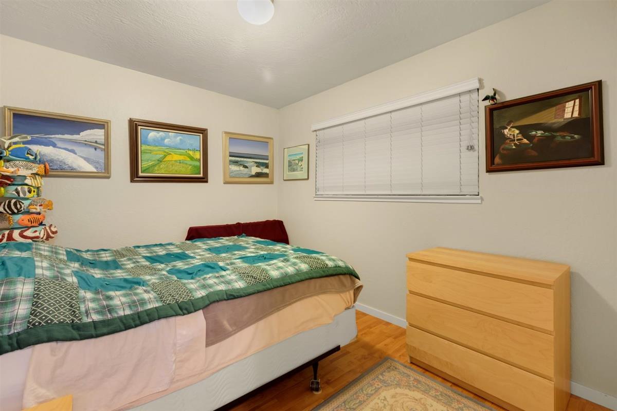 406 Pine Street, Unit A Capitola, CA 95010 - Photo 14 of 32 a bedroom with a bed and a dresser