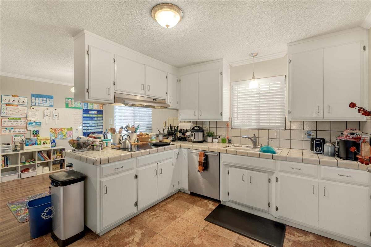 406 Pine Street, Unit A Capitola, CA 95010 - Photo 17 of 32 a kitchen with counter top space sink stove and cabinets