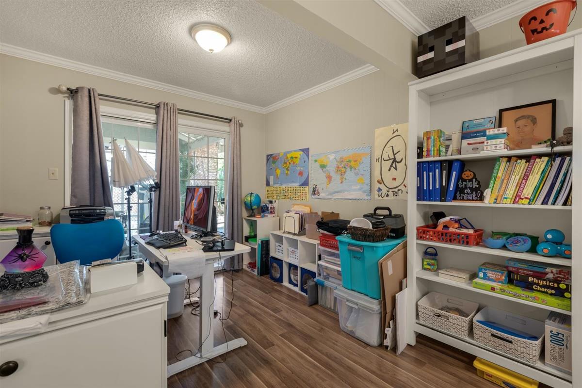 406 Pine Street, Unit A Capitola, CA 95010 - Photo 19 of 32 a room with furniture a bookshelf and a window
