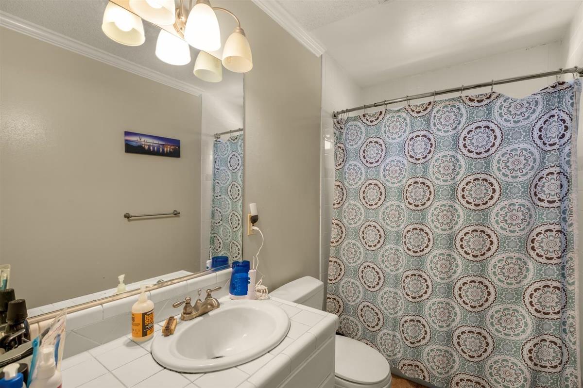 406 Pine Street, Unit A Capitola, CA 95010 - Photo 21 of 32 a bathroom with a toilet sink and mirror