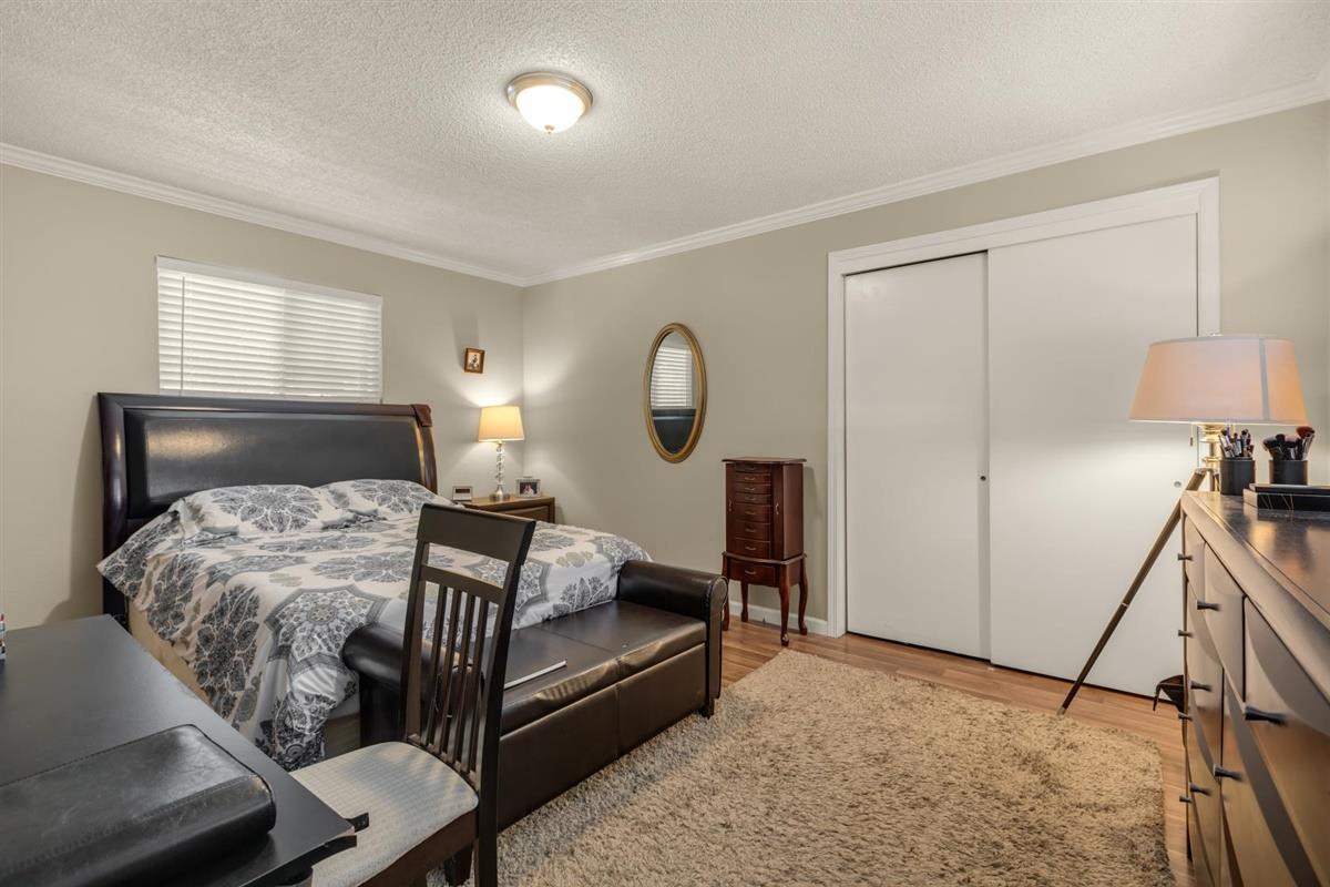 406 Pine Street, Unit A Capitola, CA 95010 - Photo 22 of 32 a bedroom with a bed and a flat tv screen on a dresser