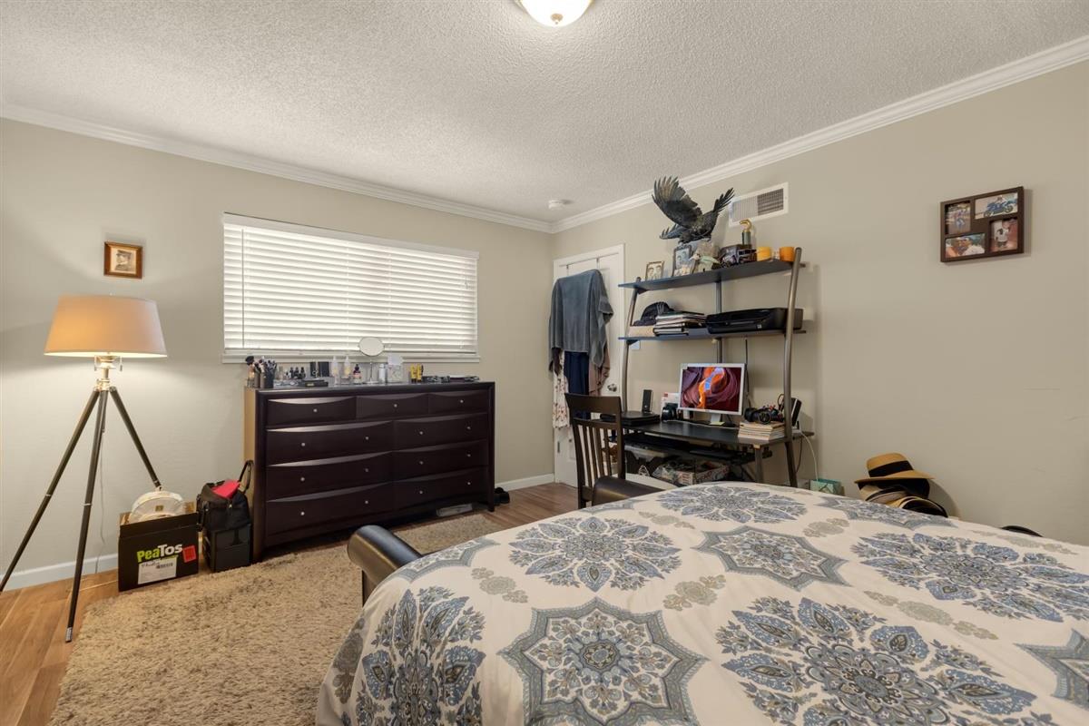 406 Pine Street, Unit A Capitola, CA 95010 - Photo 23 of 32 a bed room with a bed and a chair