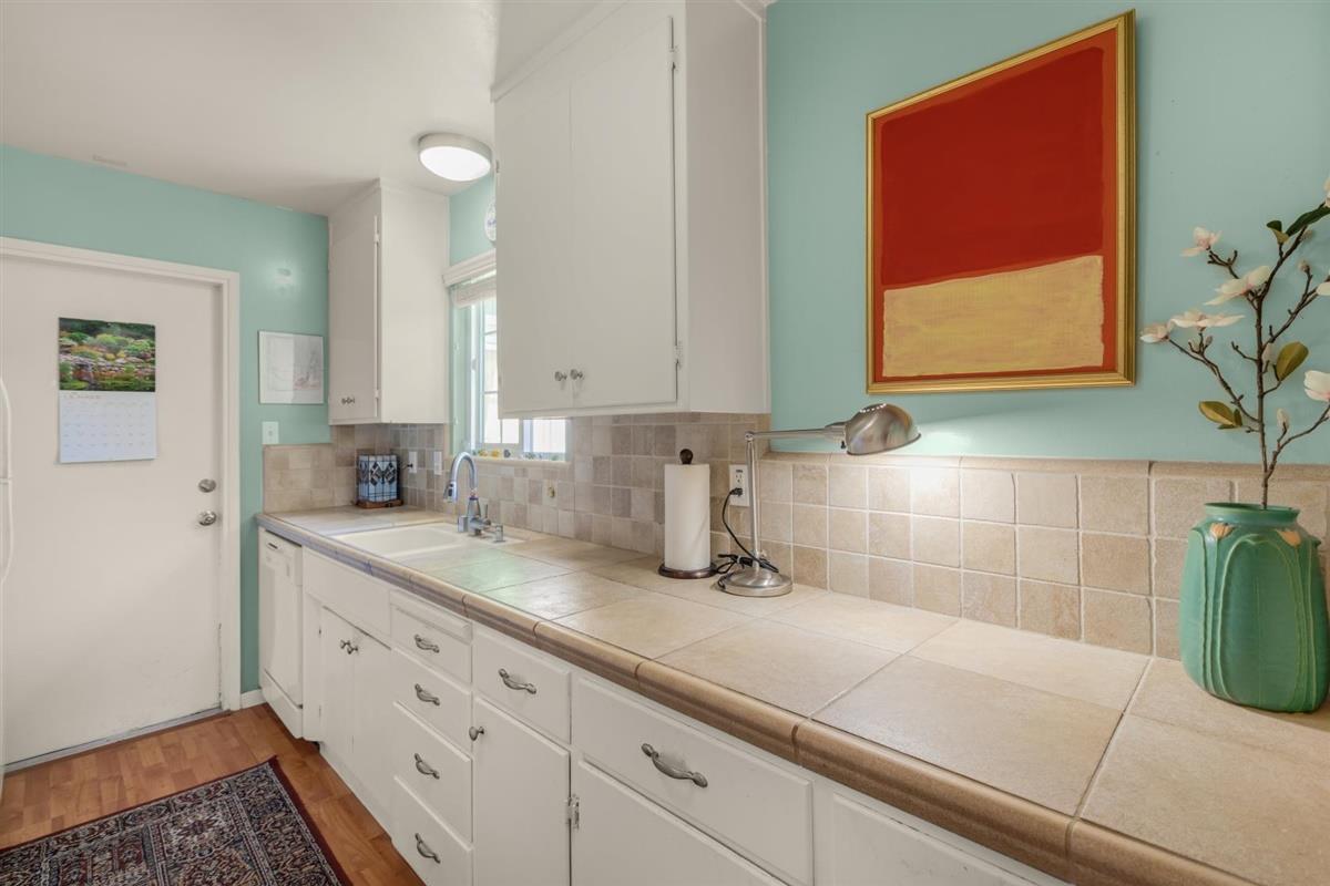 406 Pine Street, Unit A Capitola, CA 95010 - Photo 8 of 32 a kitchen with a sink and cabinets
