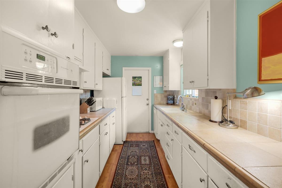 406 Pine Street, Unit A Capitola, CA 95010 - Photo 10 of 32 a kitchen with stainless steel appliances a sink stove and cabinets