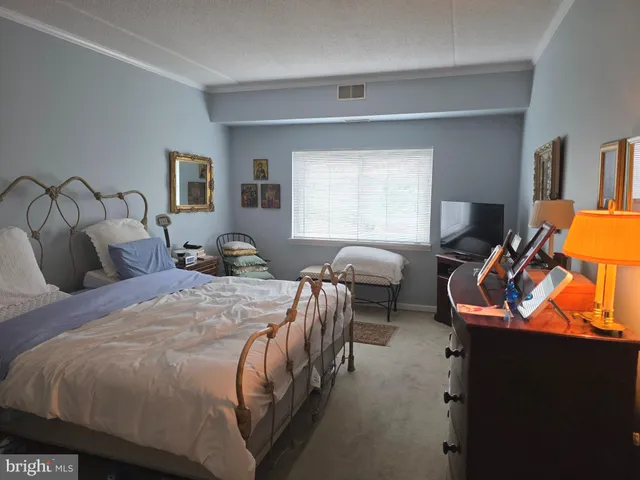 a bedroom with bed and window