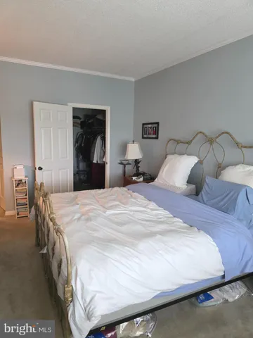 a bedroom with a bed and a night stand