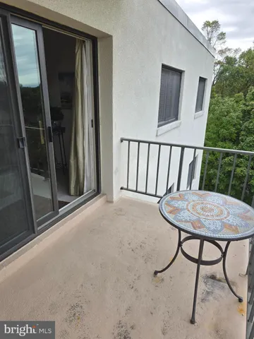 a view of a room that has a window and wooden floor