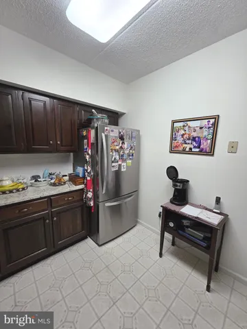 a kitchen with a cabinets and a refrigerator