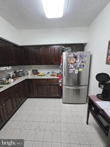 a kitchen with stainless steel appliances a stove a sink and a refrigerator