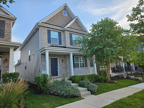 a front view of a house with garden