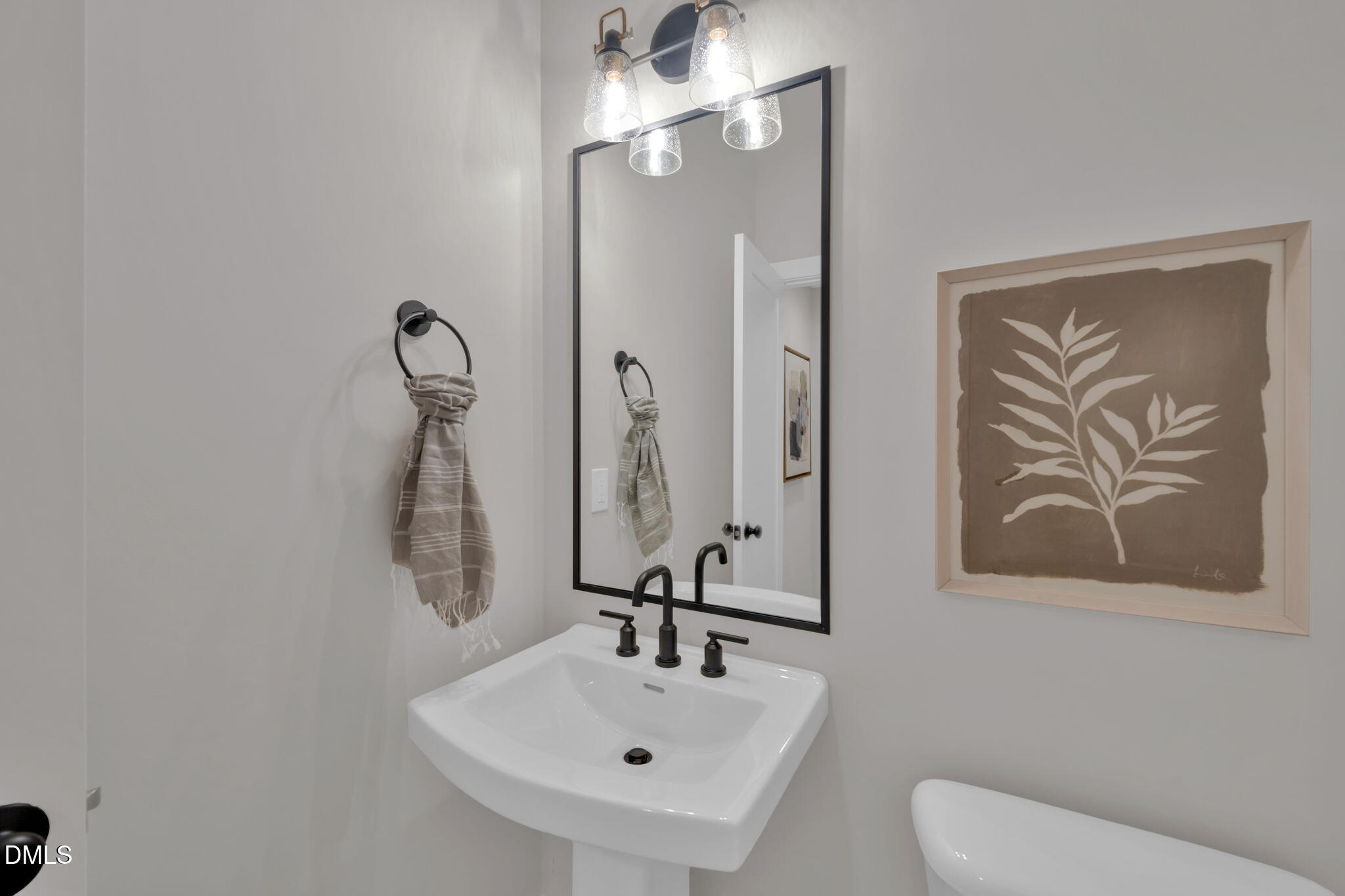966 Double Helix Road Apex, NC 27523 - Photo 7 of 36 a bathroom with a sink and mirror with toilet