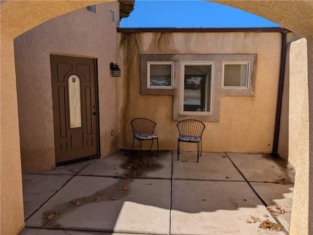a view of a door and chair in front of a house