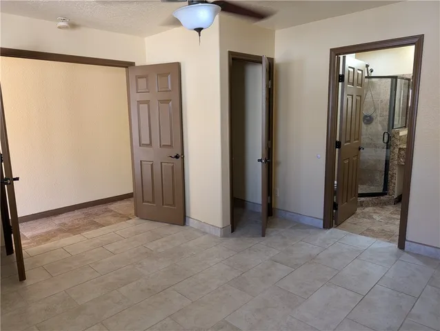 an empty room with closet and a bathroom