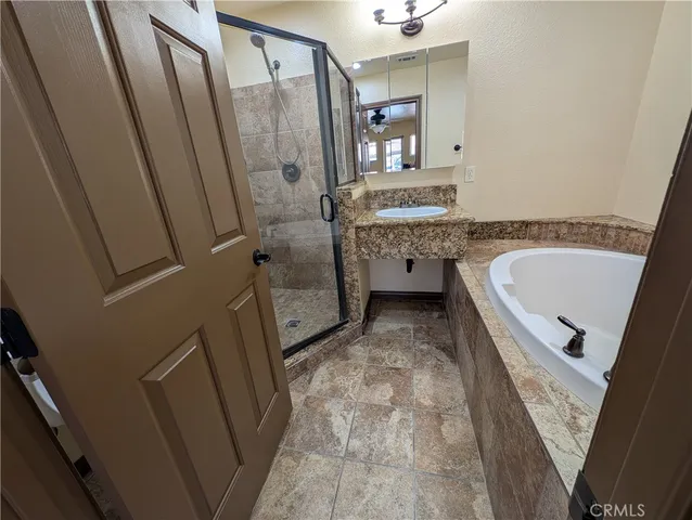 a bathroom with a tub sink and mirror