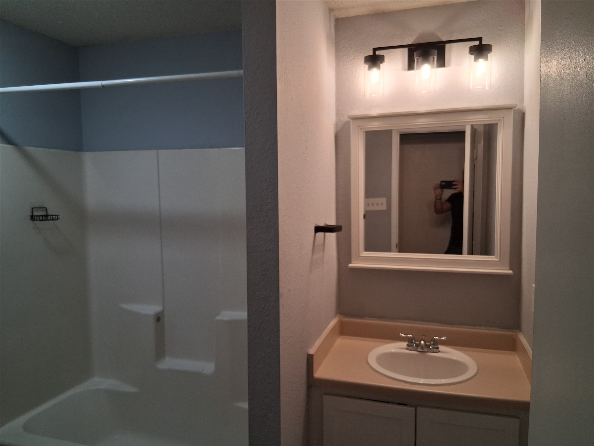 2807 West Slaughter Lane, Unit B Austin, TX 78748 - Photo 3 of 12 Full bathroom with vanity, shower combination, and a textured wall